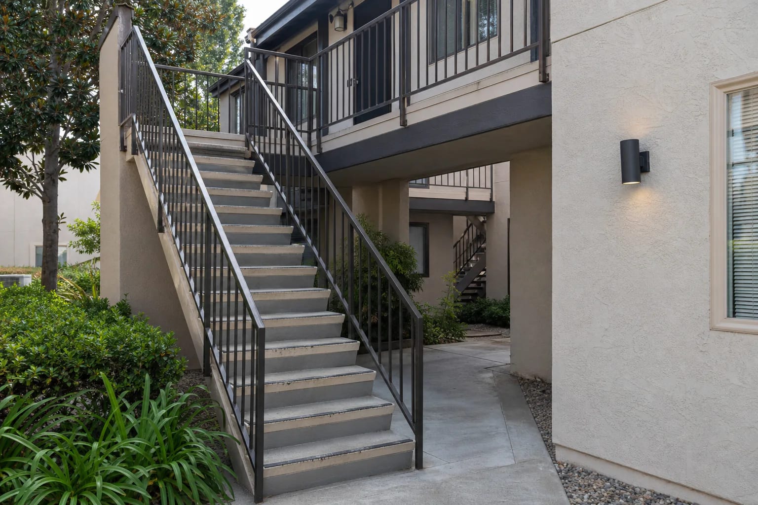 Empty exterior stairway and landing in a California apartment courtyard in daylight
